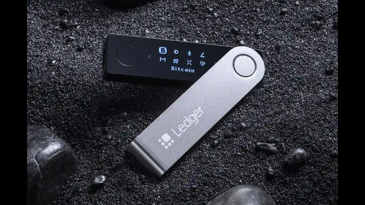 Dispositivo Ledger mostrando a interface de uso com Bitcoin, ideal para armazenamento seguro de criptomoedas em um fundo escuro e texturizado.