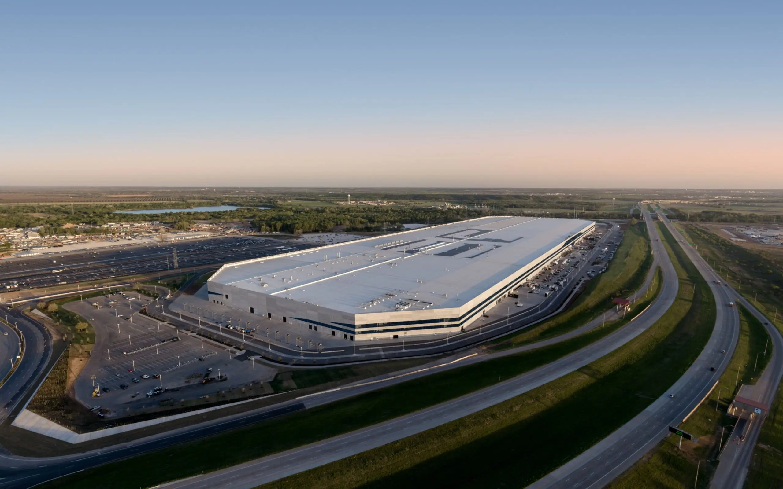 Aerial view of Tesla Gigafactory in Austin, Texas, showcasing the large structure and surrounding area.