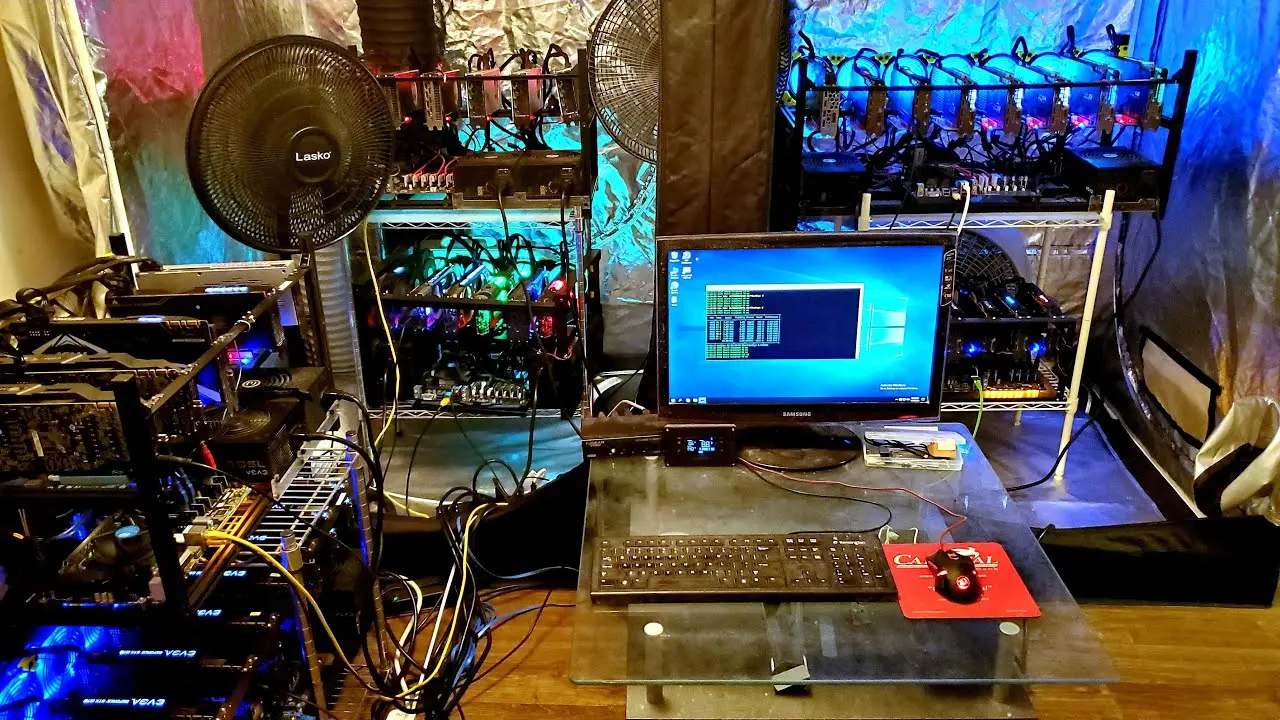 A home office with multiple GPU mining rigs and a computer setup for Bitcoin mining.