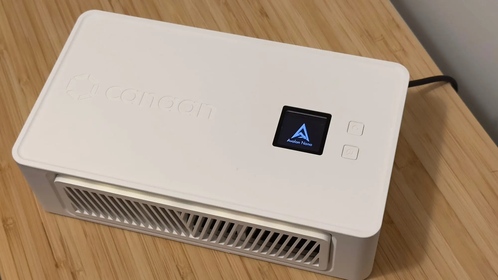 Canaan Avalon Nano 3S miner with display on a wooden surface