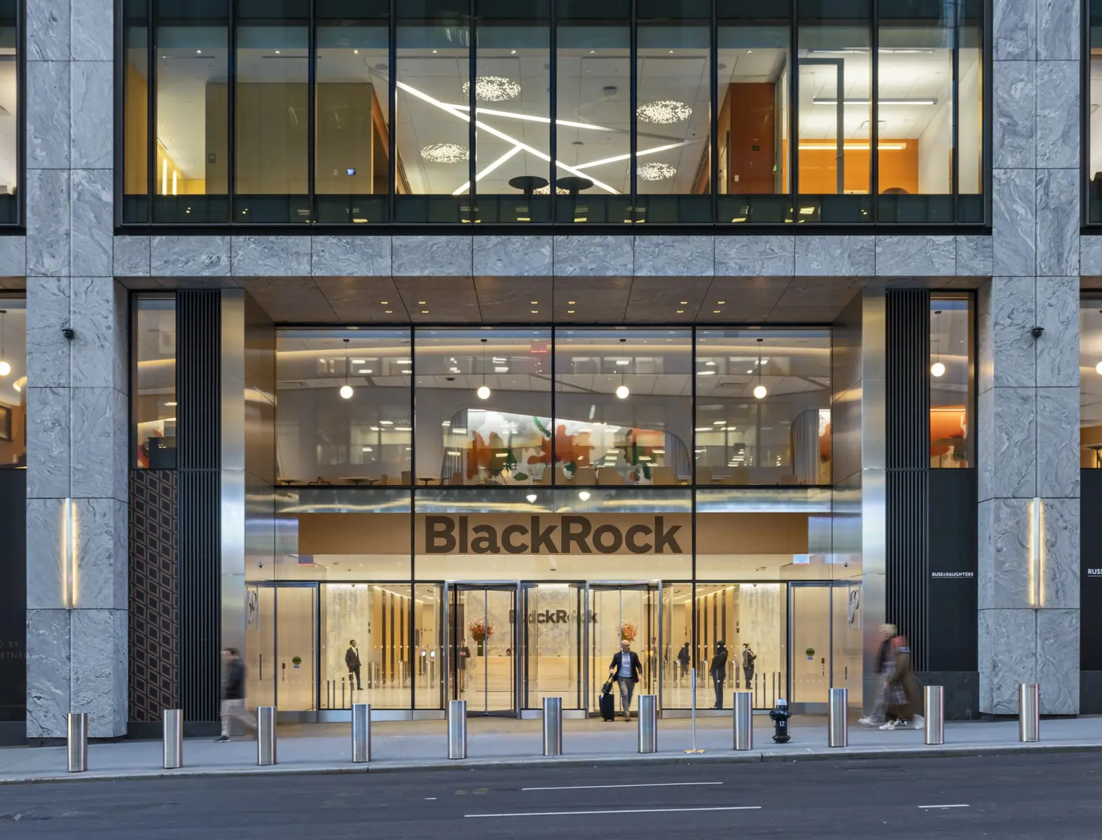 Exterior view of the BlackRock headquarters entrance in New York City with large signage and glass doors.