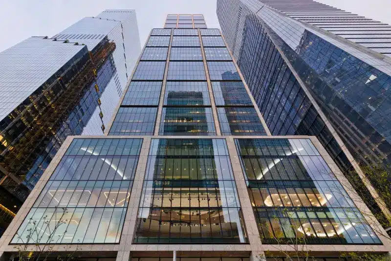 Low-angle view of the modern glass and steel BlackRock headquarters building in New York City.