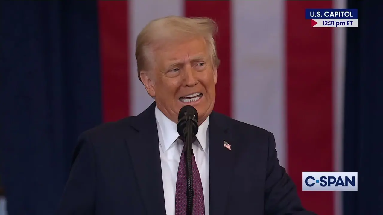 Donald Trump speaking at a podium with an American flag in the background