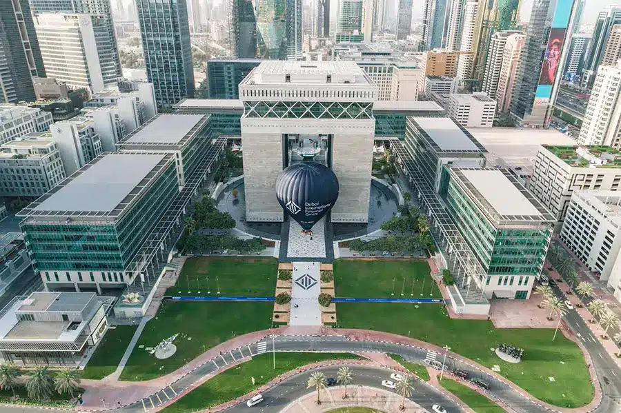 Aerial view of the Dubai International Financial Centre gate building with a large branded hot air balloon