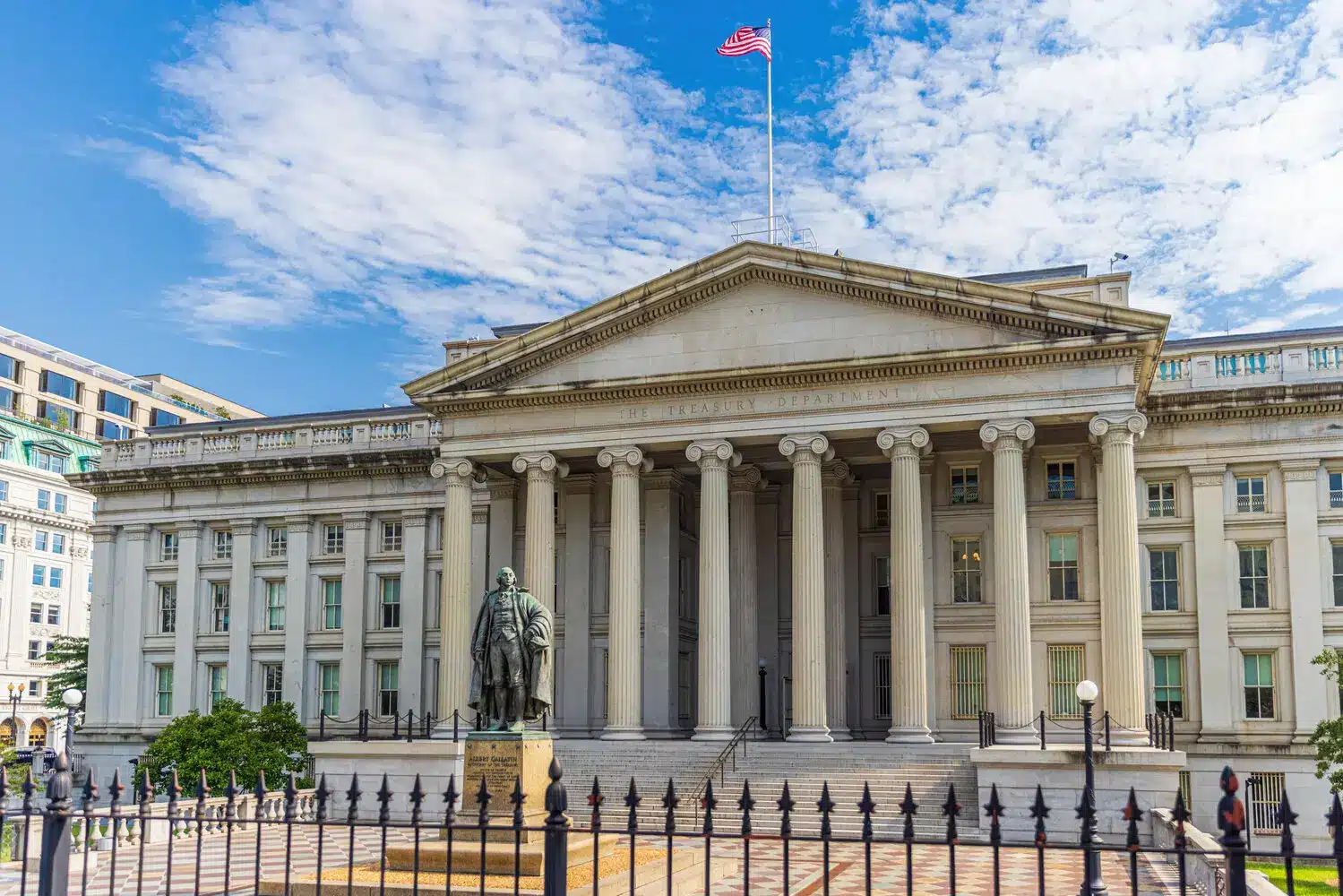 Front view of the neoclassical US Department of the Treasury building in Washington DC with an American flag flying
