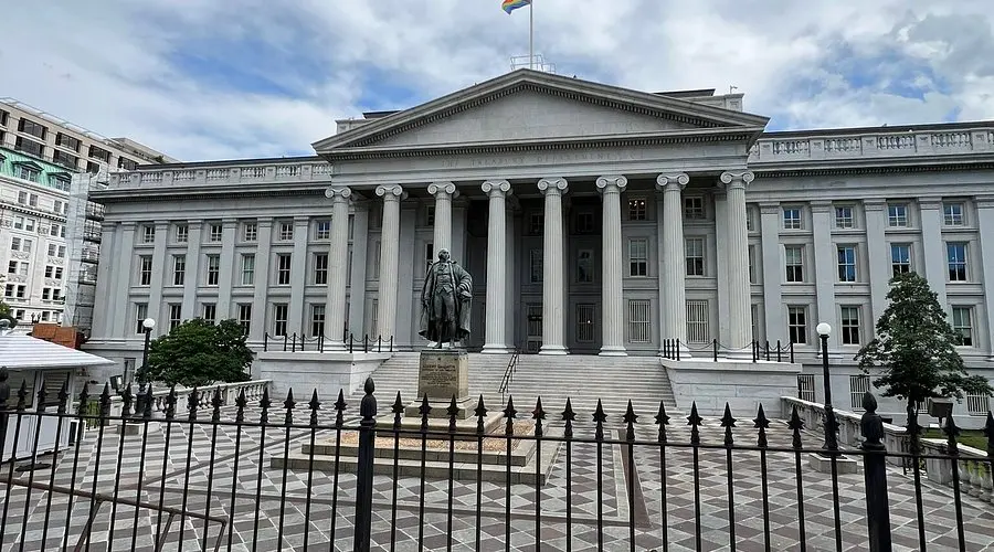 The exterior of the US Department of the Treasury building in Washington, D.C., featuring a statue of Albert Gallatin.