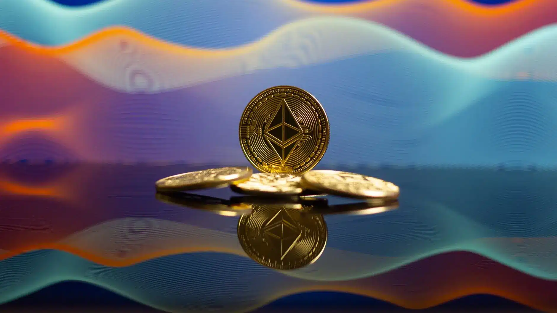 Gold Ethereum coins resting on a reflective surface against a colorful wave-patterned background