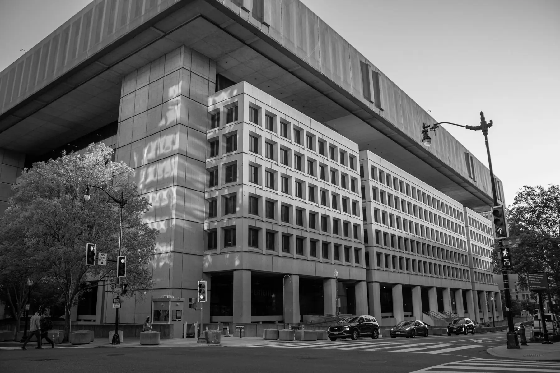 Black and white wide shot of the brutalist architecture of the Federal Reserve building in Washington, D.C.