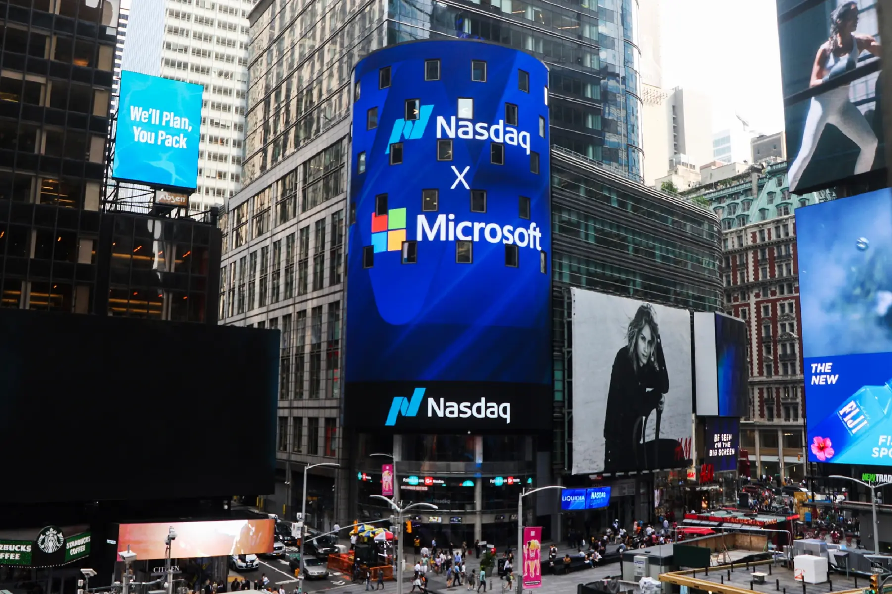 The Nasdaq MarketSite building in Times Square featuring a large blue digital screen with Microsoft branding.