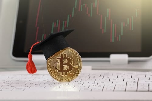 a bitcoin with a graduation cap on