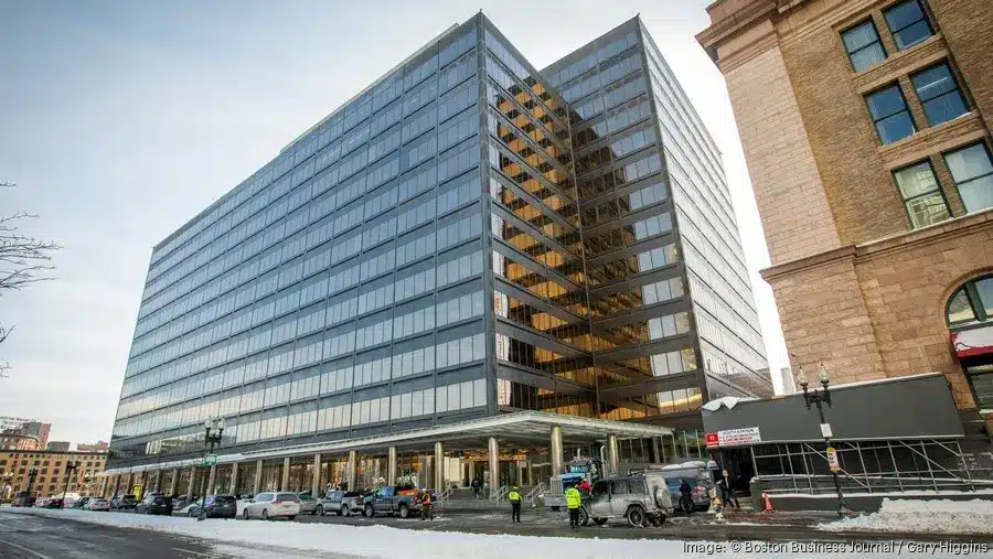 Modern office building with large glass facades and snowy surroundings.