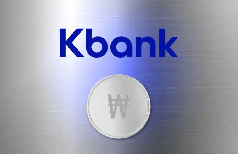 Kbank logo in blue text above a silver coin featuring the South Korean Won symbol on a brushed metal background
